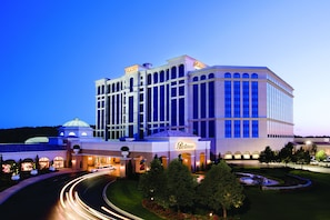 A large, multi-story hotel with a prominent dome and arched windows, featuring a well-lit entrance and landscaped gardens. - Belterra Casino Resort (Florence)