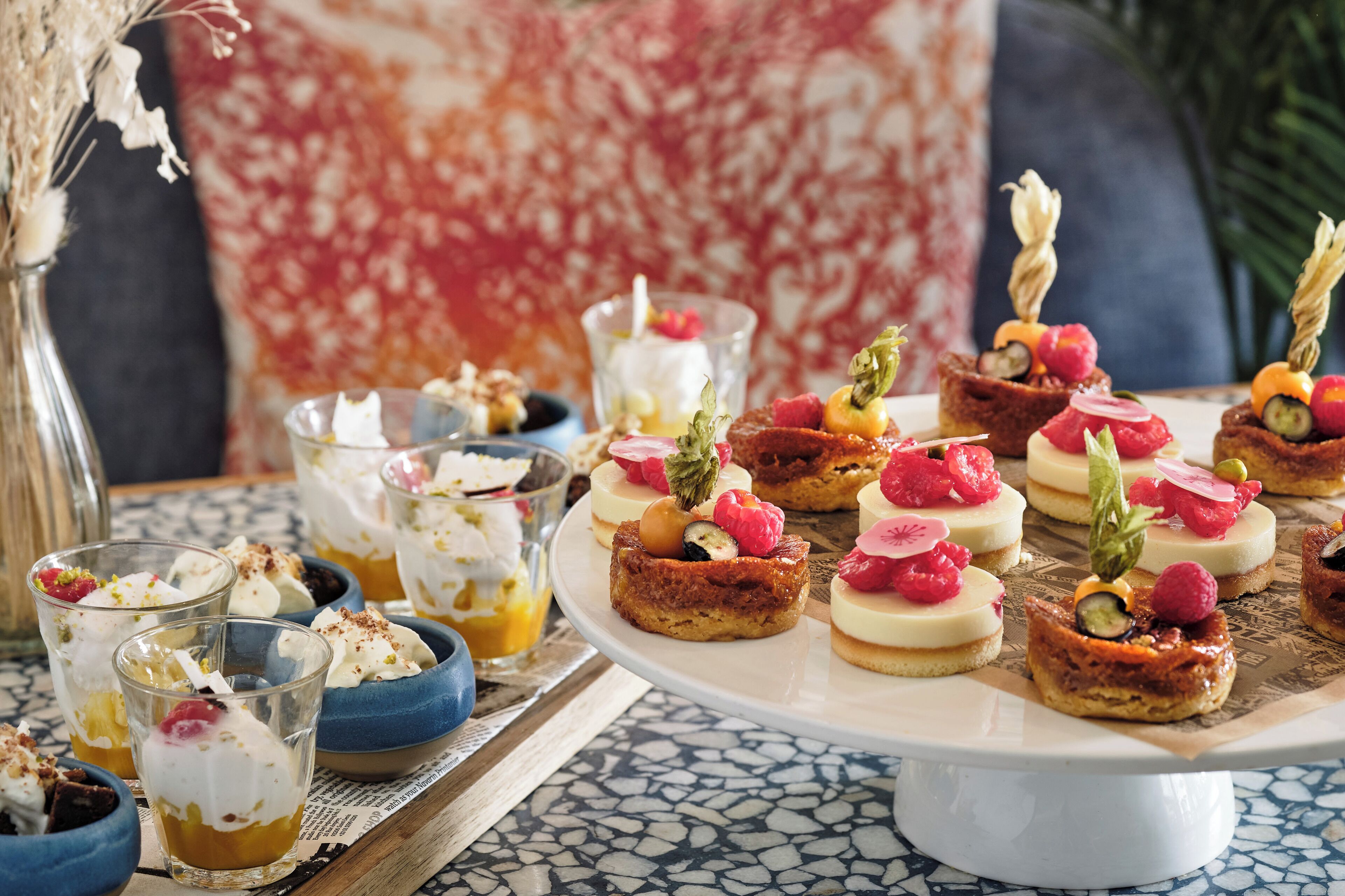 A dessert table with various sweet treats and beverages.
