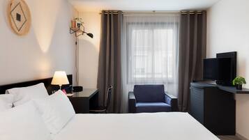 Family Room | Premium bedding, desk, laptop workspace, blackout drapes