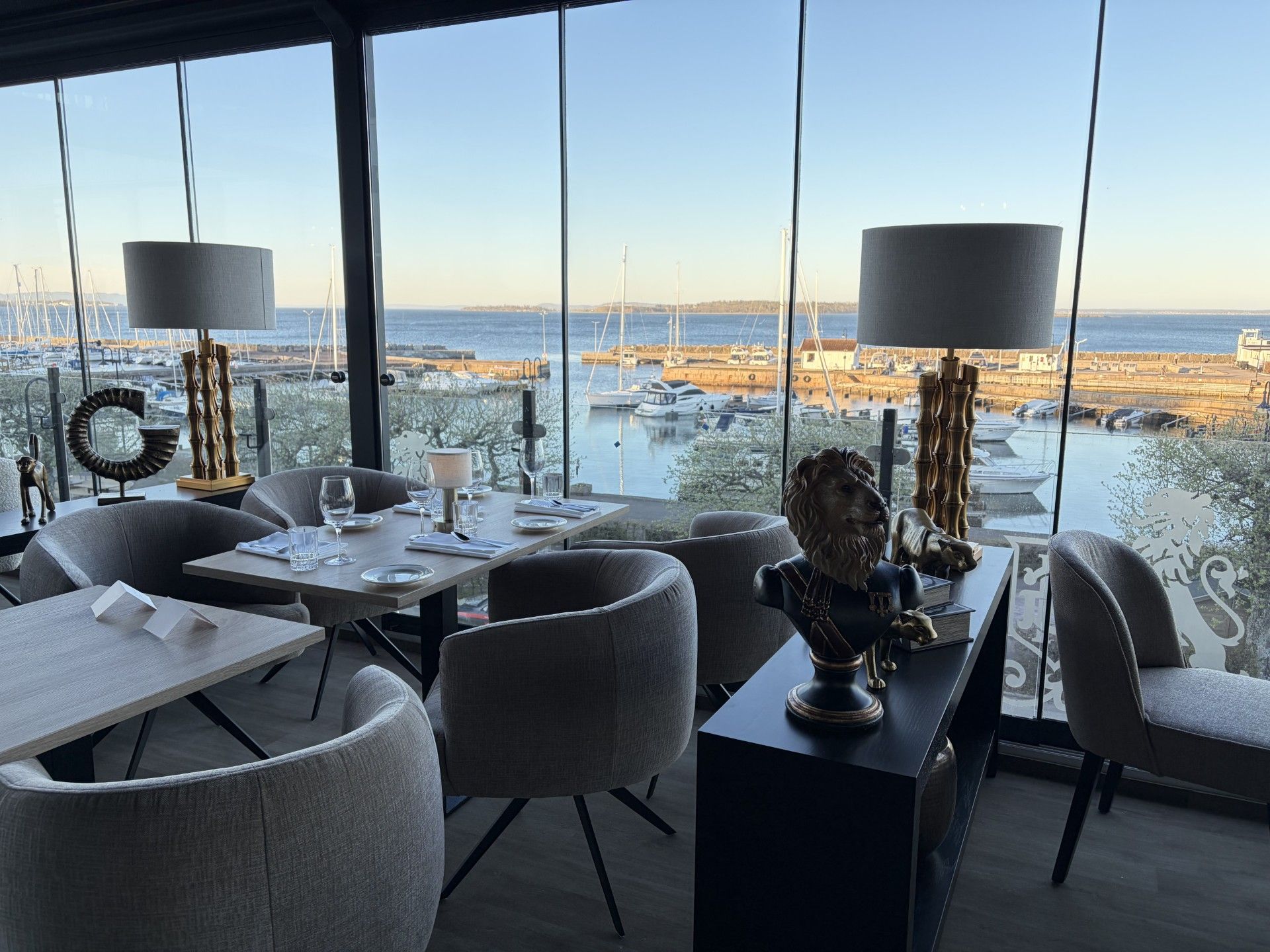 A modern dining area with a view of a marina.
