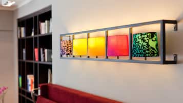 A wall-mounted light fixture with five square panels, each with a different pattern.