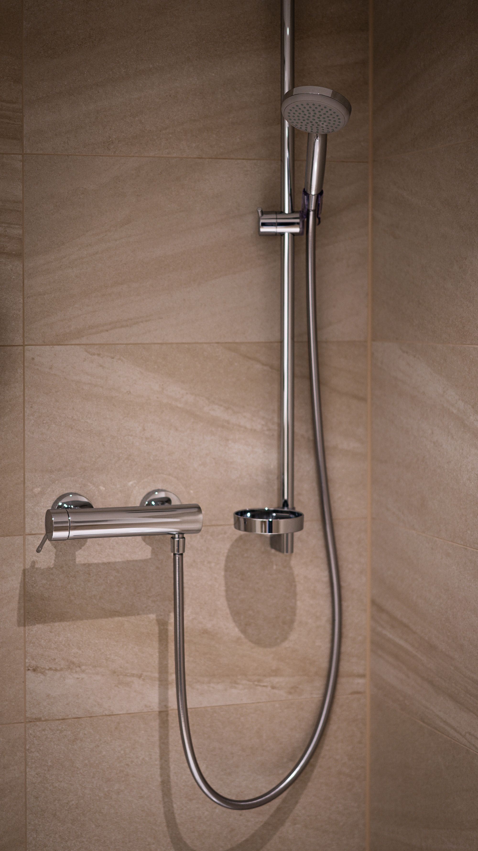 A shower with a handheld showerhead and a handheld faucet.