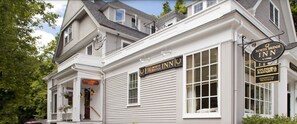 A two-story building with a sign for "North Bridge Inn" and "Coldwell Banker Residential Brokerage".