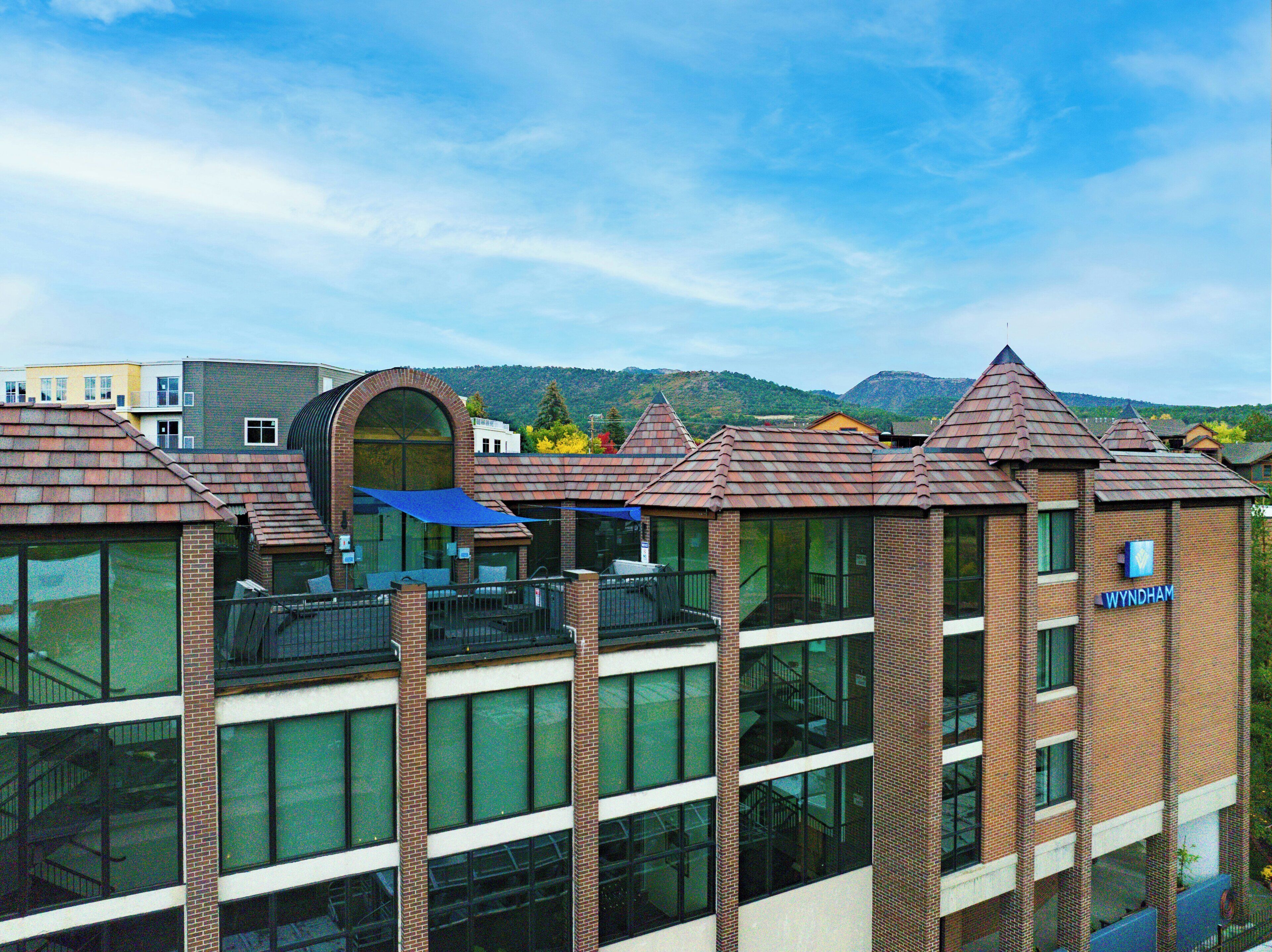 A multi-story building with a brick facade, large windows, and a distinctive arched entrance.