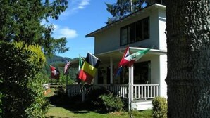 A two-story house with a porch and a flag display.