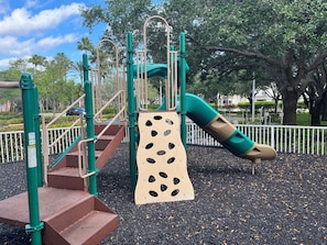 Children can play on the slide, climb the net, and use the steps in this playground.