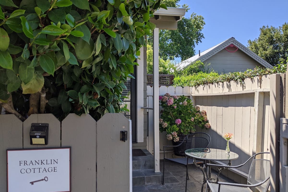 A wooden fence with a sign reading "FRANKLIN COTTAGE".
