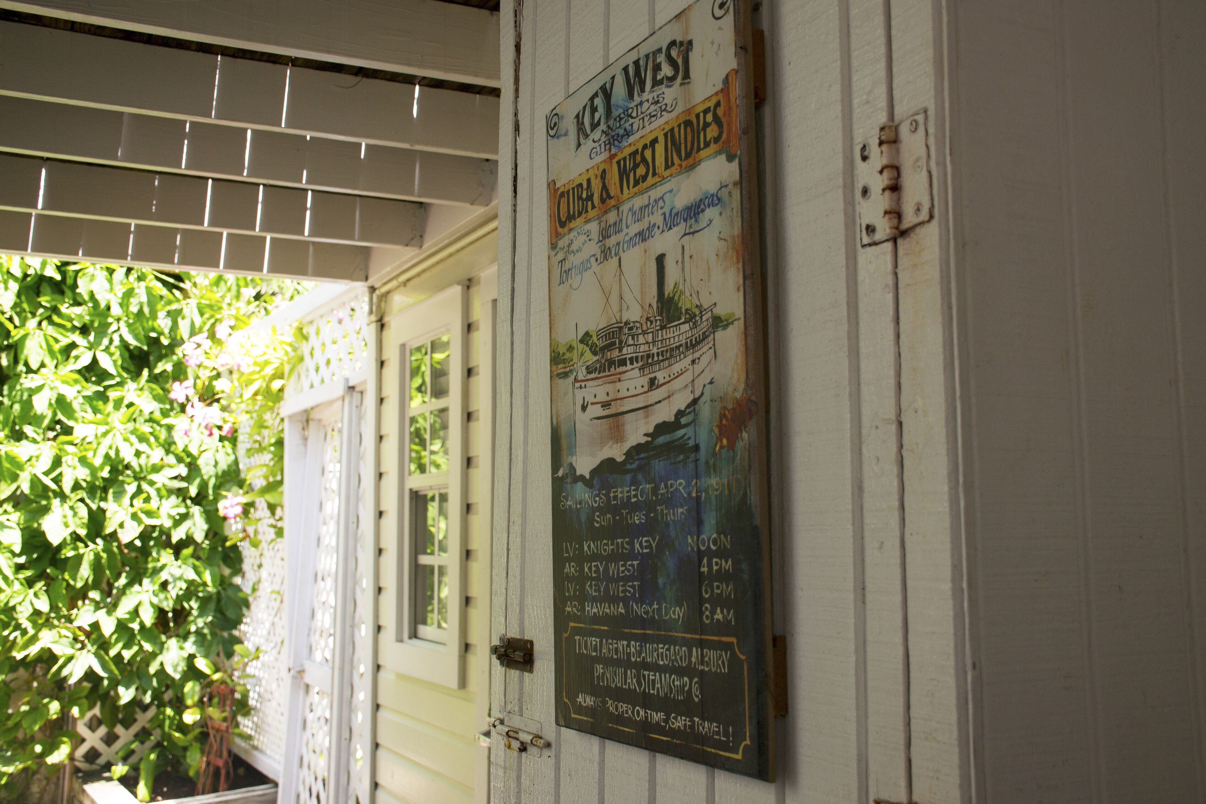 A poster advertising a cruise ship service with departure times and ticket agent information.