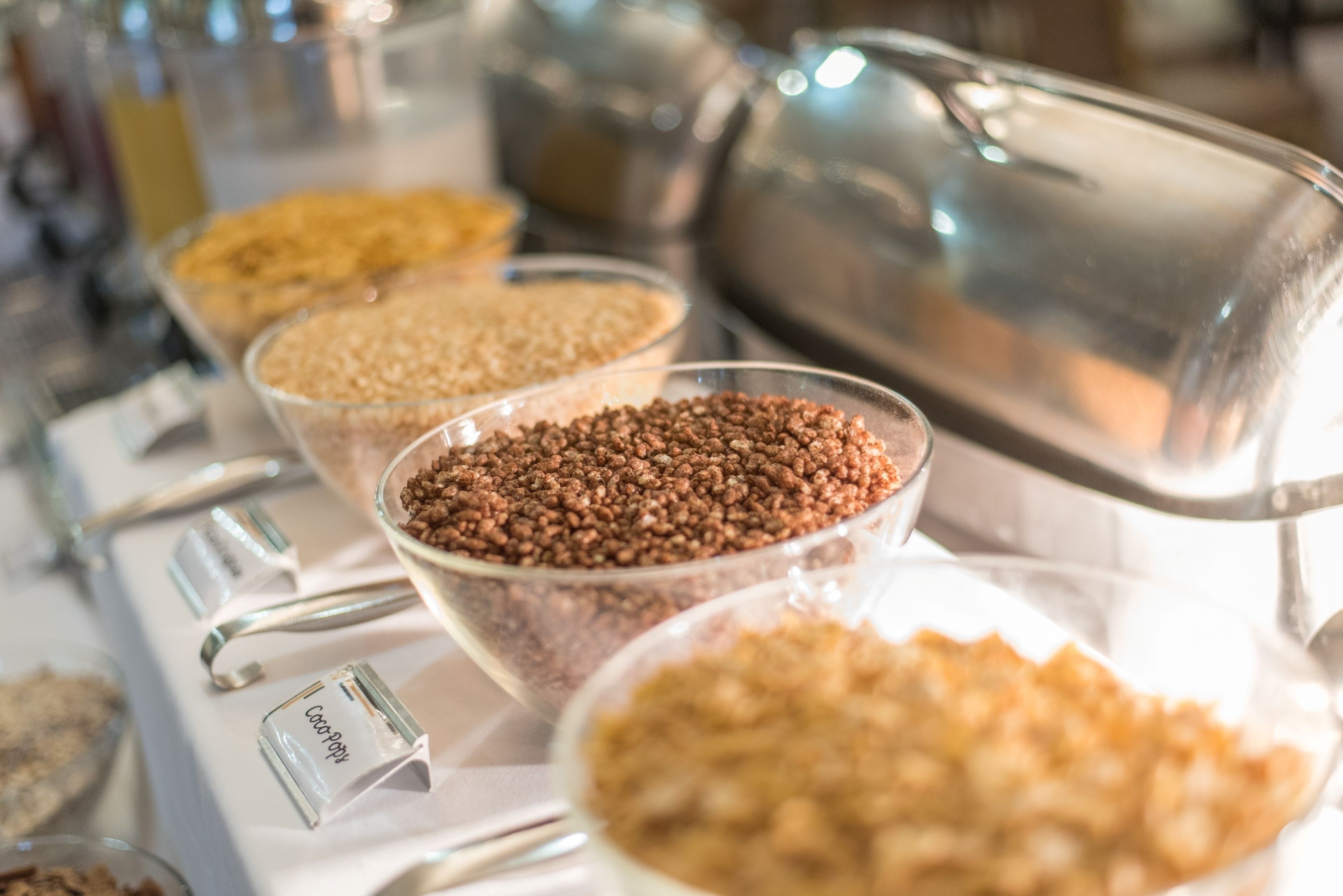 A buffet with various food items in bowls and containers.