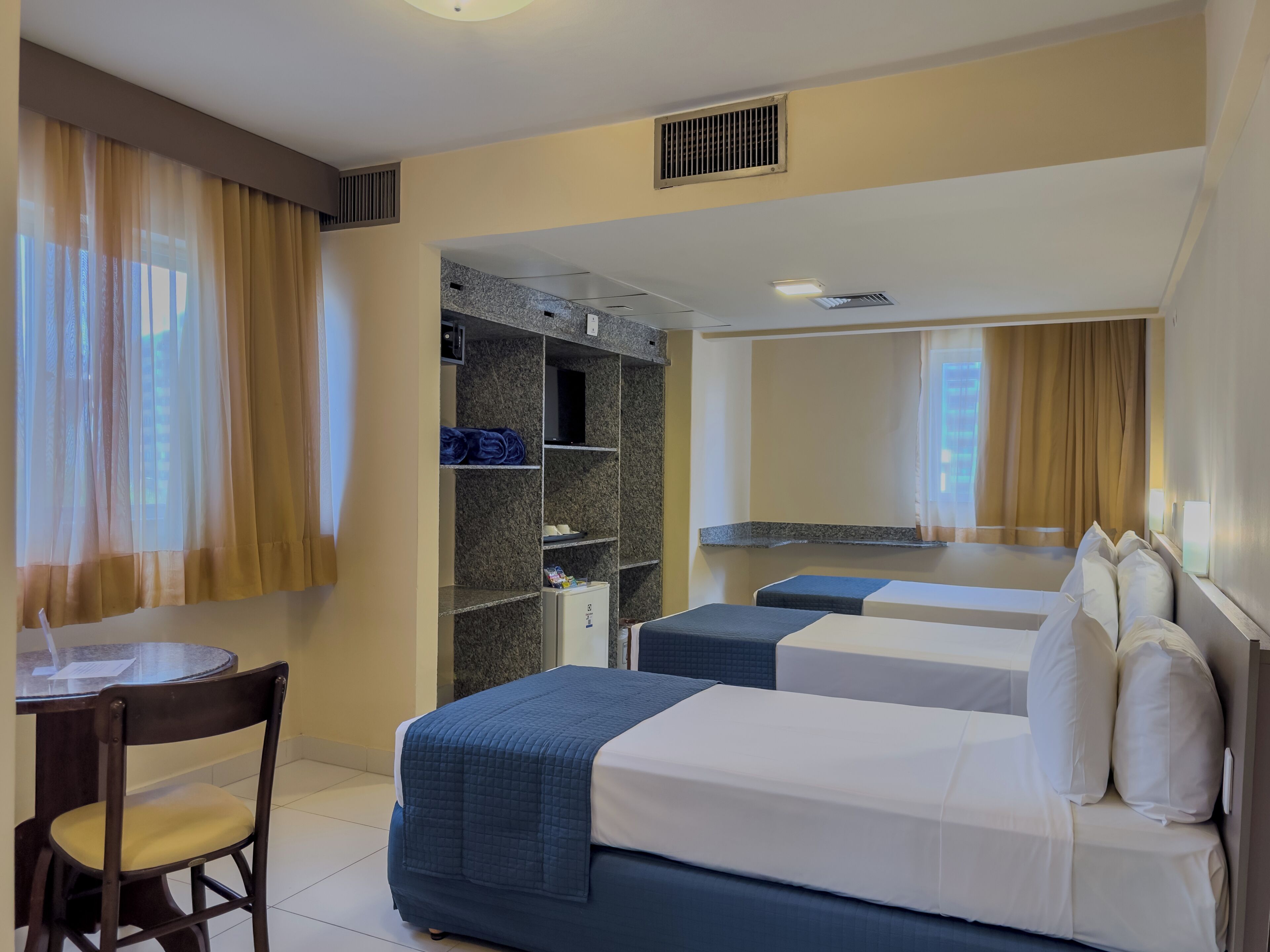 Standard Triple Room | Minibar, in-room safe, desk, laptop workspace