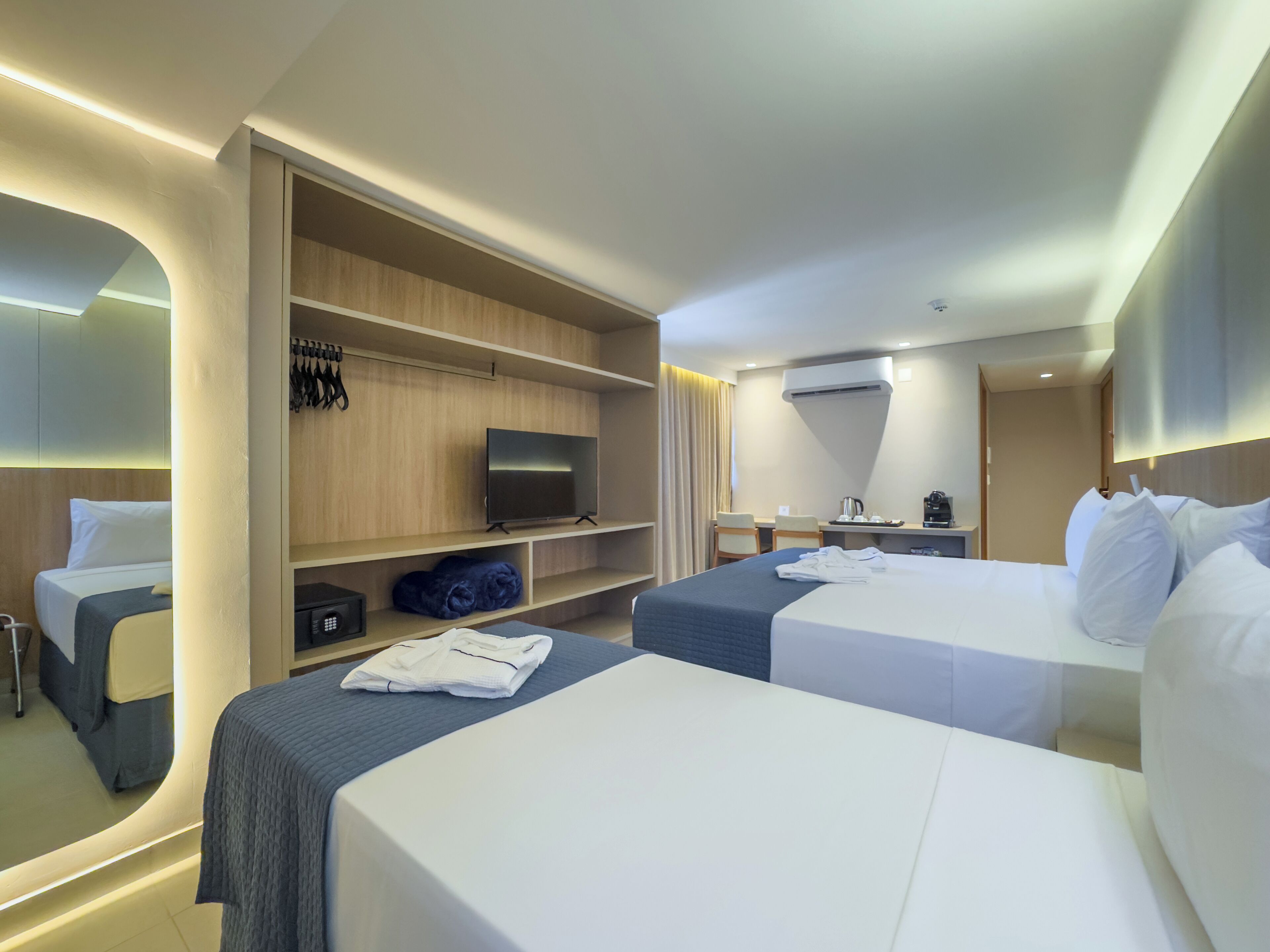 Deluxe Triple Room | Minibar, in-room safe, desk, laptop workspace