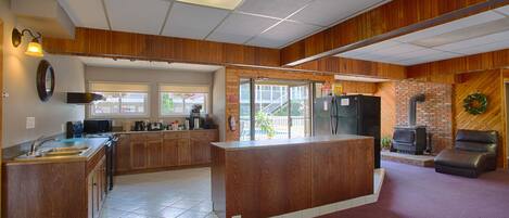 A spacious kitchen with wooden cabinets, a built-in stove, and a refrigerator.