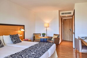 A hotel room with a bed, two chairs, a desk, and a lamp. - Zafiro Tropic (Alcúdia)