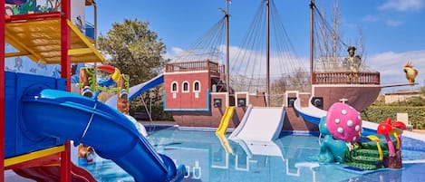 A water park with slides, a pirate ship, and a play structure.
