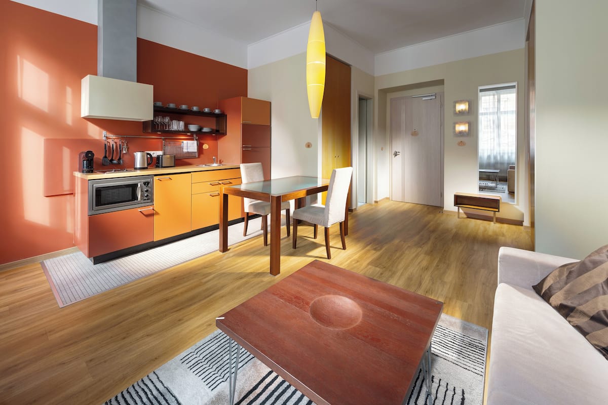 Una cocina moderna con comedor, muebles de madera y vista al salón.