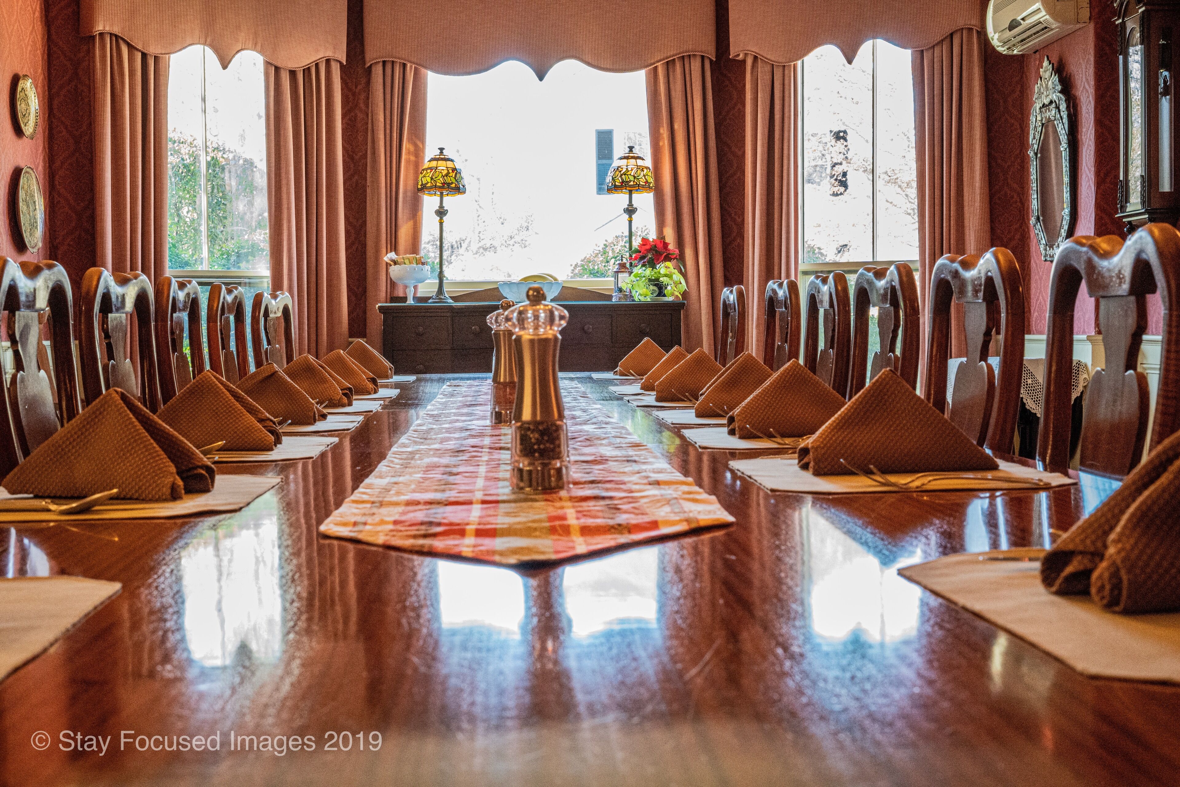 A conference room with a long table, chairs, and a decorative centerpiece.