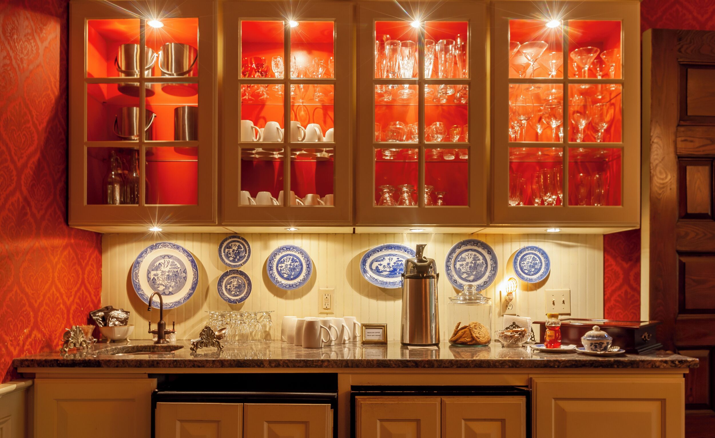 A kitchen with a central island, a built-in oven, and a coffee maker.