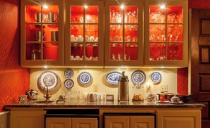 A kitchen with a central island, a built-in oven, and a coffee maker.