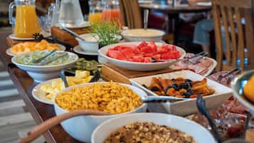 A breakfast buffet with various food items and beverages.