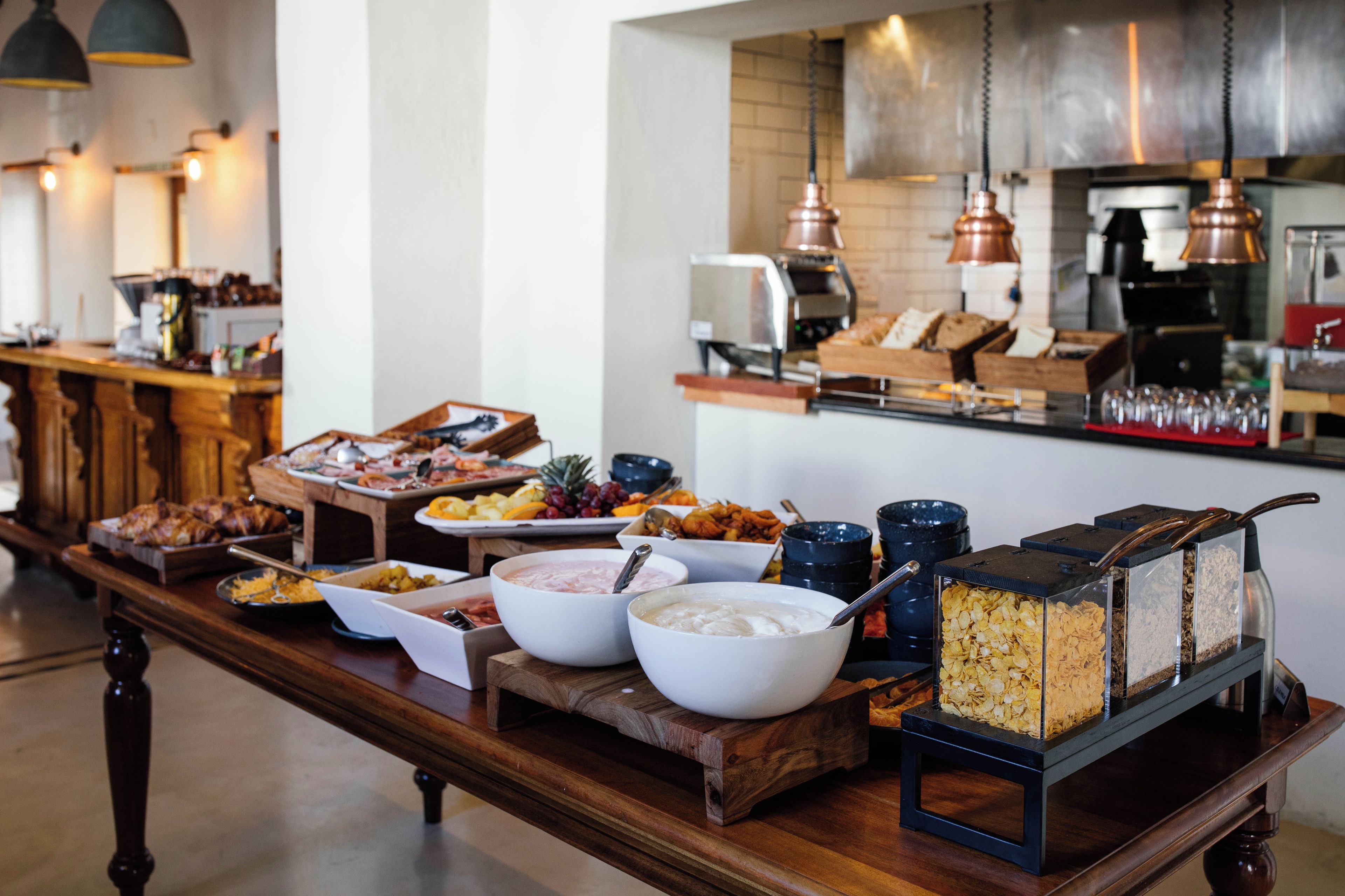 A buffet with various food items and a coffee station.