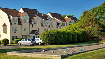 Townhouses with a lawn and croquet court, offering a tranquil setting.