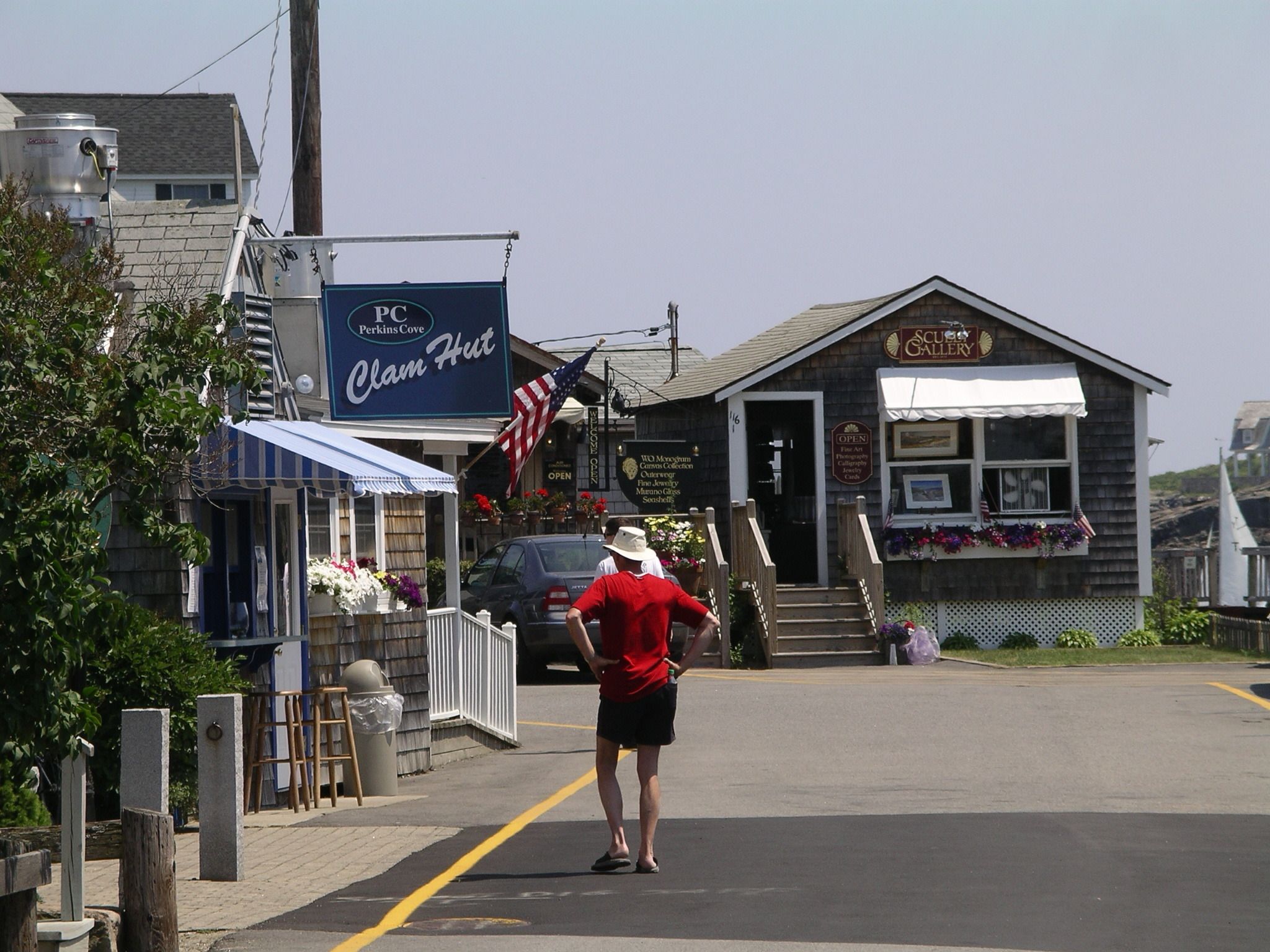 A coastal town with a 'Clam Hut' and a 'SCU Gallery' building.