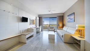 A modern hotel room with a balcony, a flat-screen TV, a desk, a sofa, and a lamp. - Bull Eugenia Victoria & Spa (San Bartolomé de Tirajana)