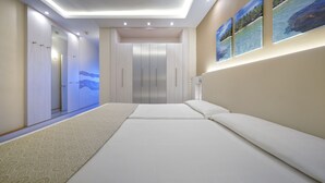 A modern hotel room with a large bed, a walk-in closet, and a view of the ocean through the window. - Bull Eugenia Victoria & Spa (San Bartolomé de Tirajana)
