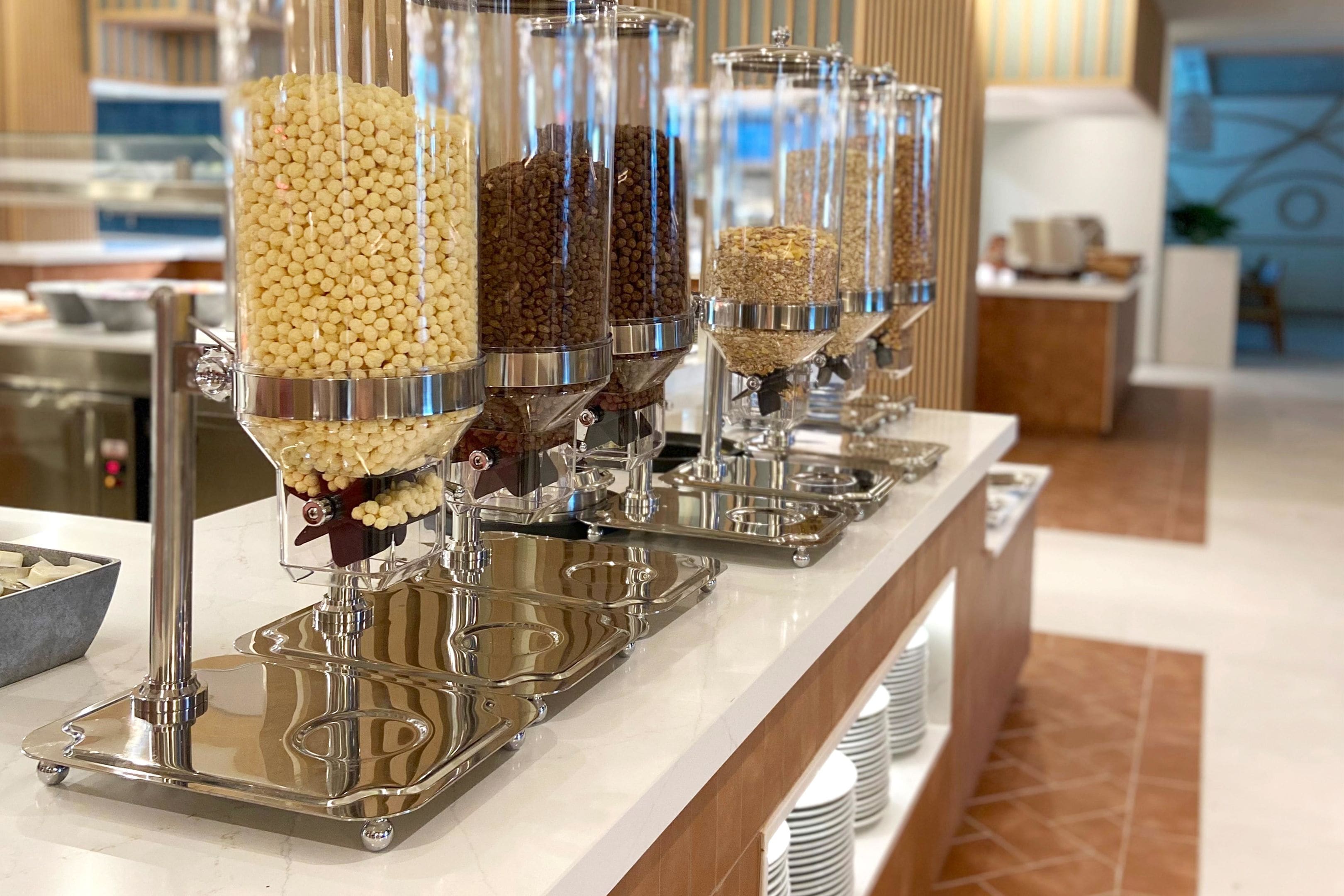Montaje de buffet con múltiples dispensadores llenos de diferentes granos y legumbres.