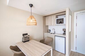 A compact kitchen with a toaster, sink, and a small refrigerator. - Servatur Puerto Azul (Mogan)