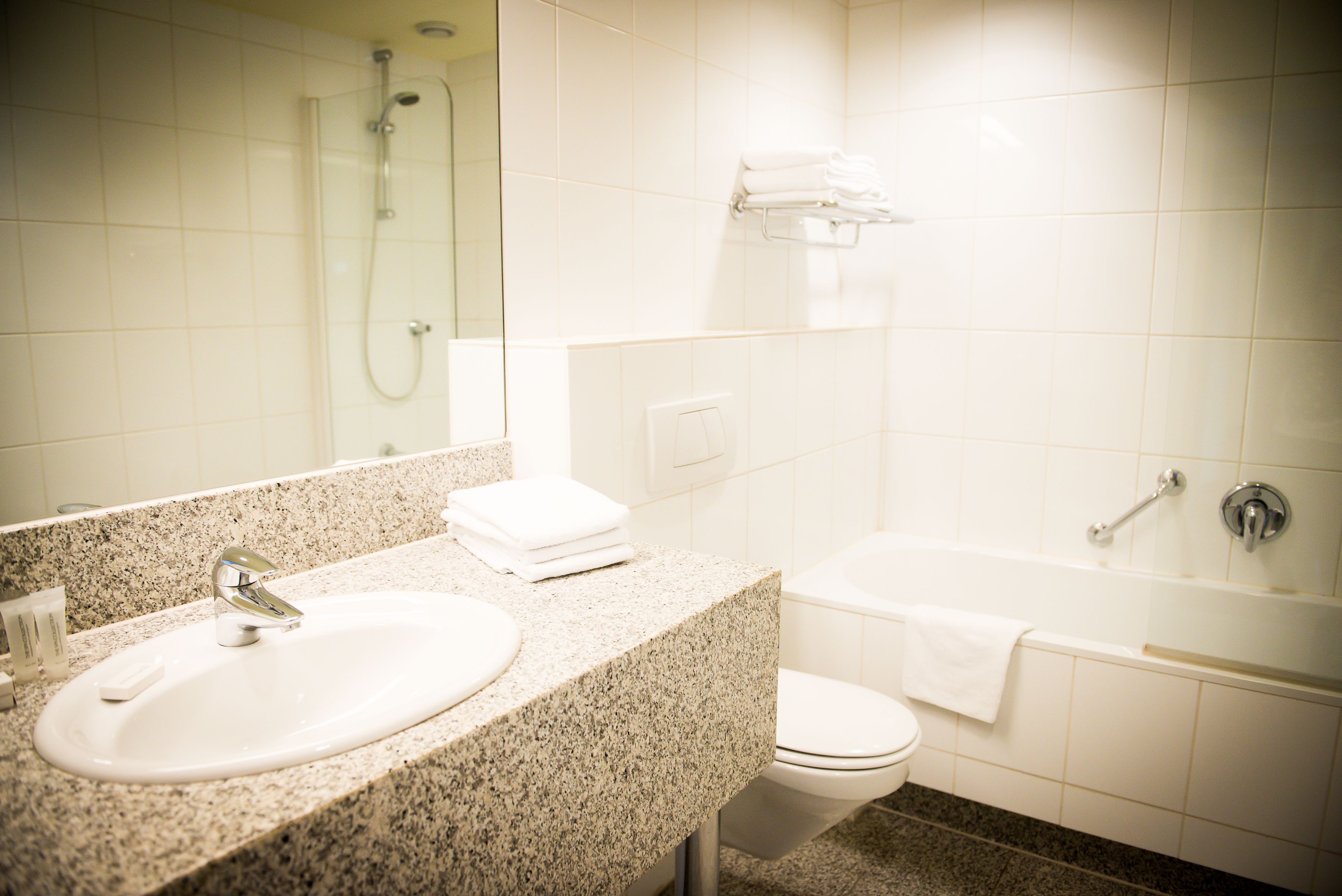 A bathroom with a sink, toilet, and bathtub.