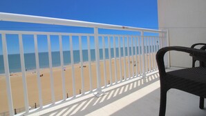A balcony with a view of a beach and ocean. - Ocean Sands Resort, Oceanfront, Virginia Beach by Vacatia (Virginia Beach)