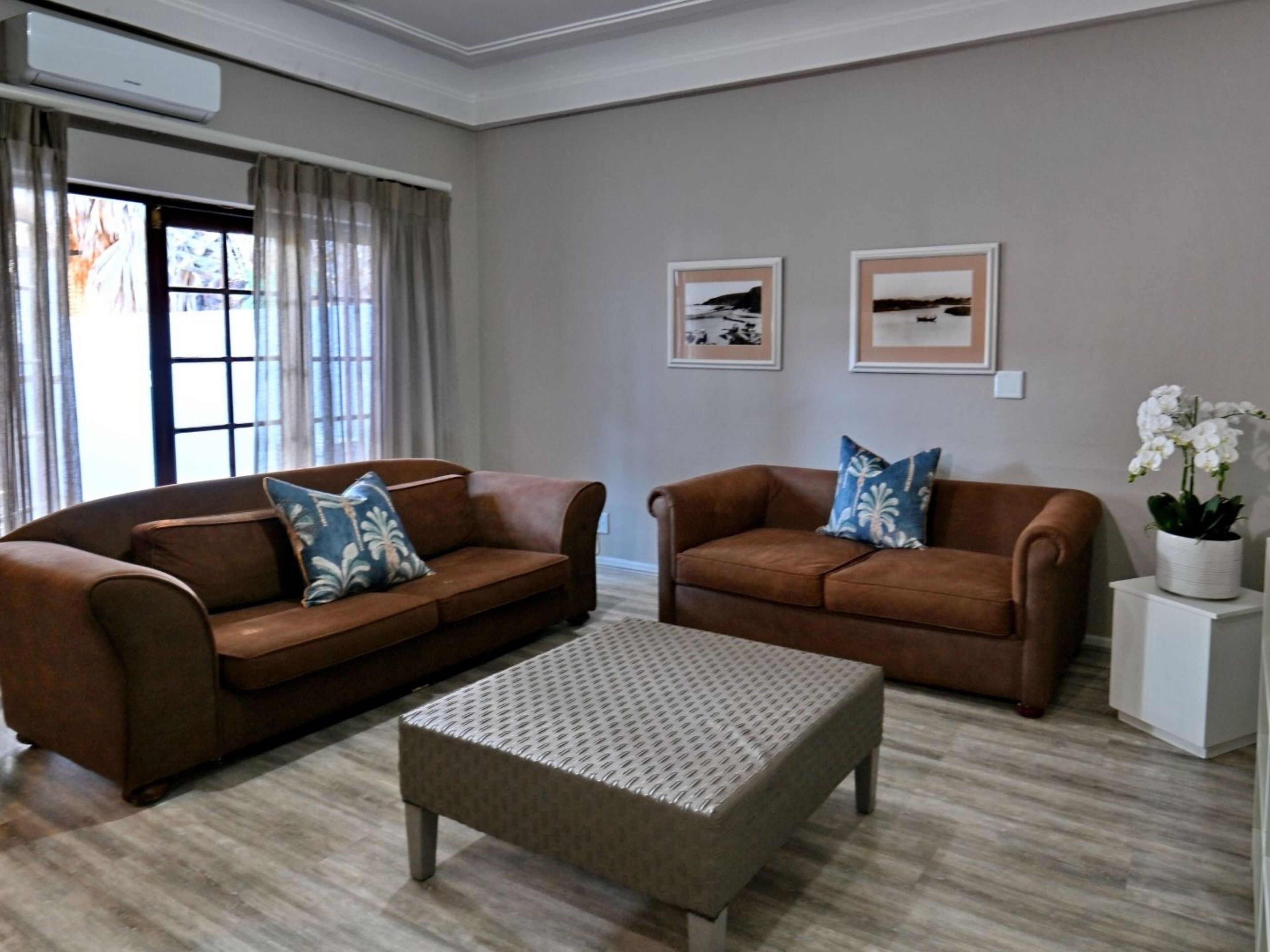 Deluxe Two Bedroom Apartment | Living area | 32-inch flat-screen TV with satellite channels, TV