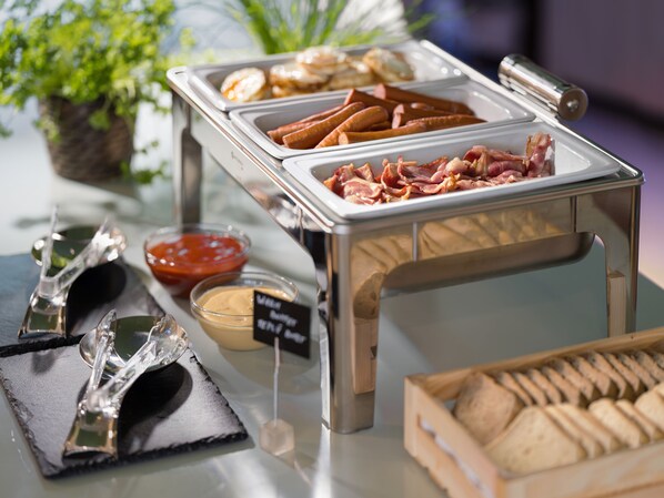 A buffet with various food items, including meats, dips, and bread. - Hotel Michael (Prague)