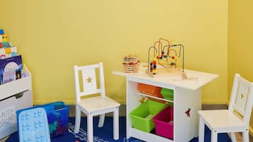 Children can play and learn with a bead maze and wooden blocks at this play area.