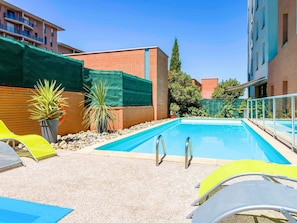 Outdoor pool, open 9:00 AM to 9:00 PM, pool loungers