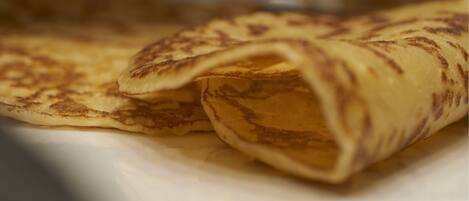 A plate with rolled crepes.