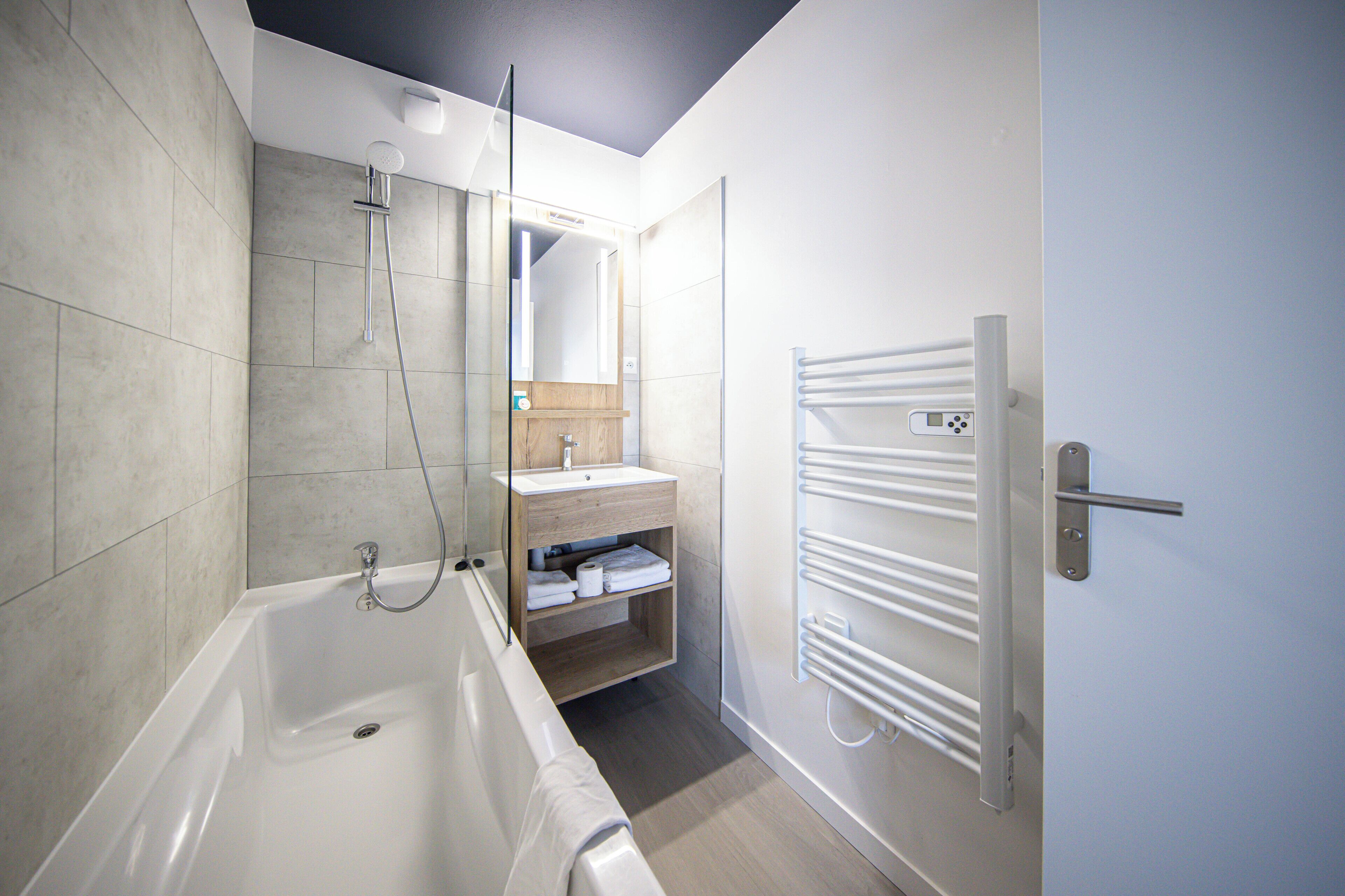 Bathtub, hair dryer, towels, soap