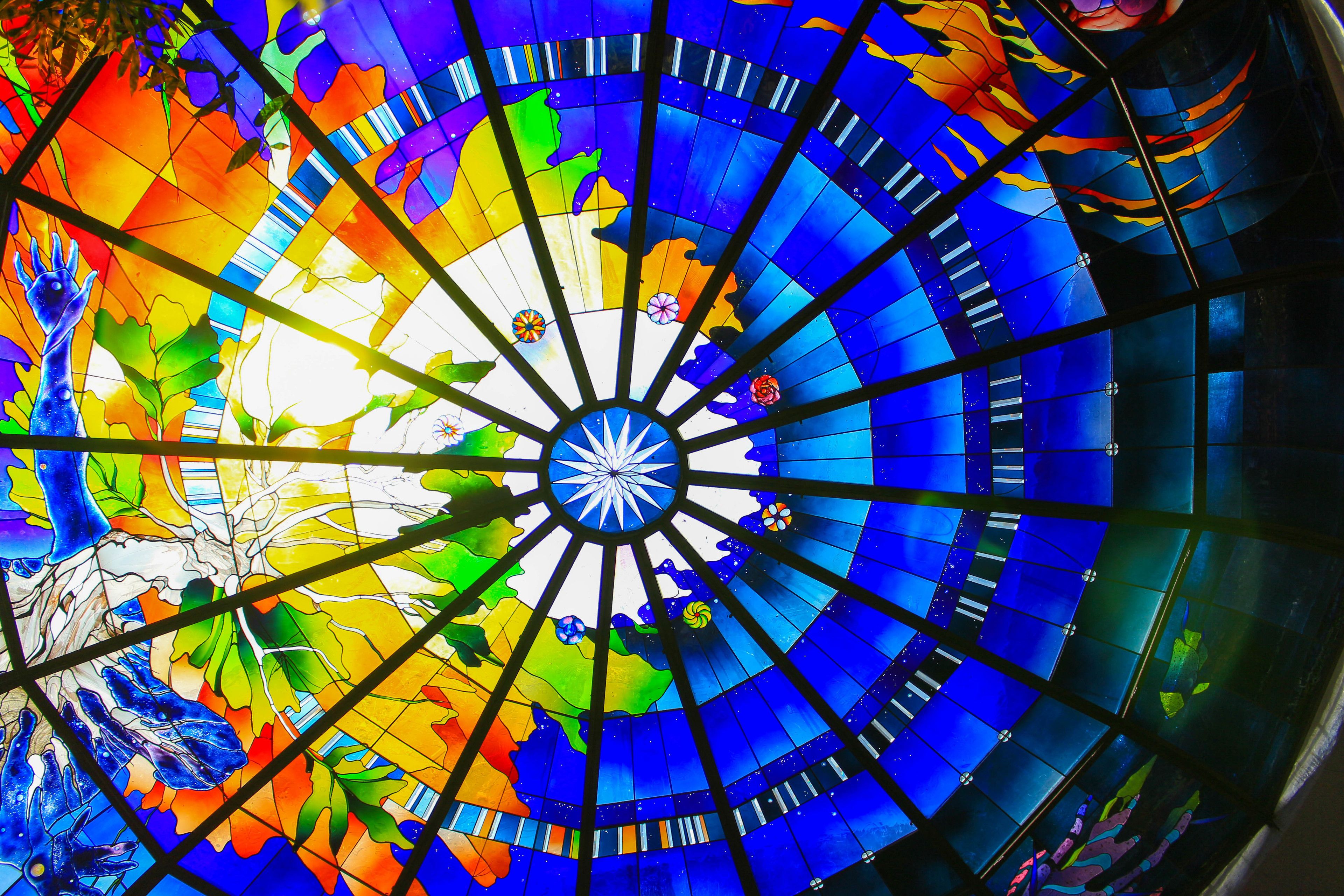 A stained glass dome with a radial design and a central star.