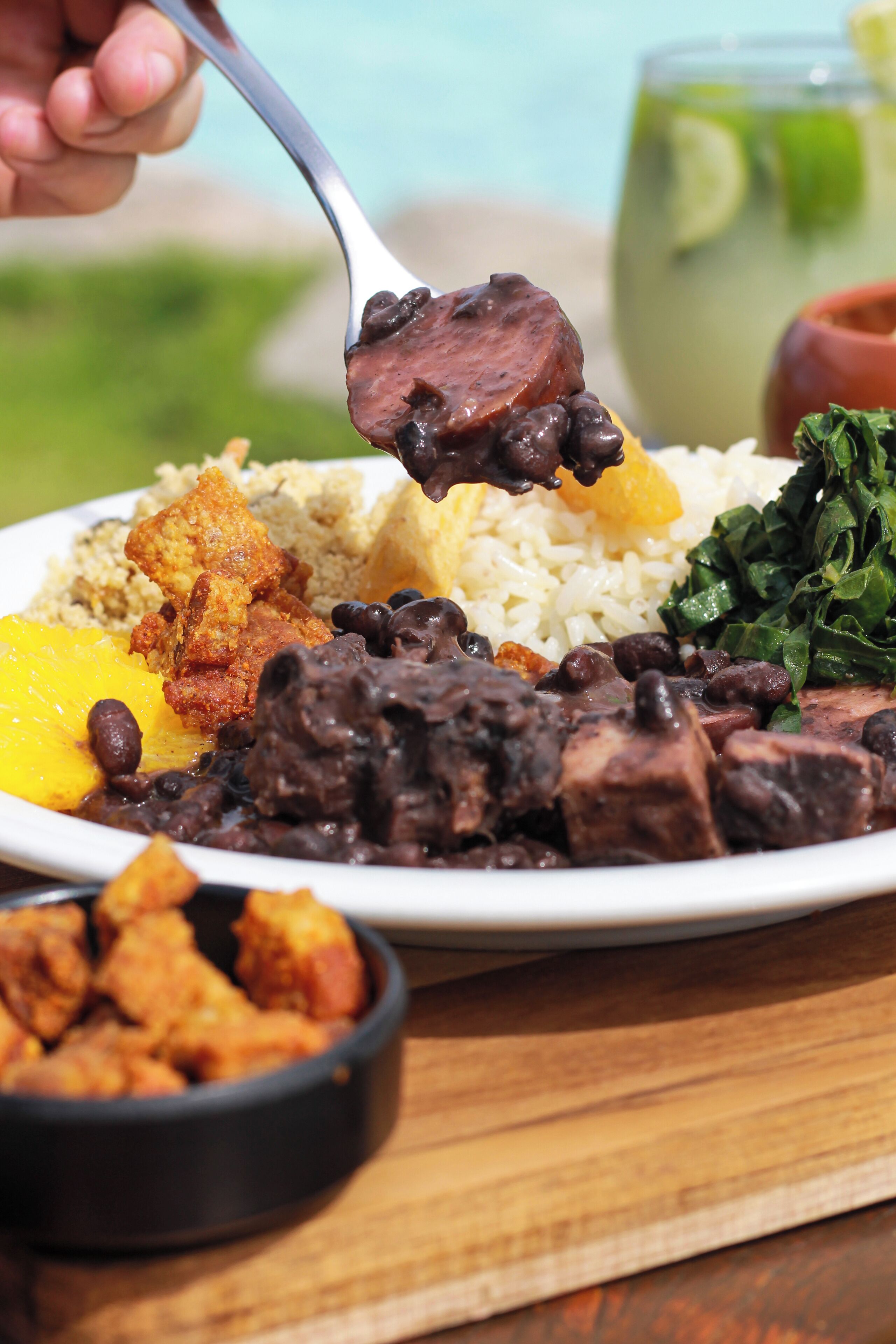 A plate of food with rice, beans, meat, and vegetables.