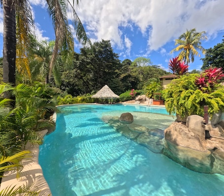 Outdoor pool, open 6 AM to 6 PM, sun loungers. Borinquen Thermal Resort
