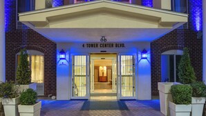 The entrance to a building with a sign reading '4 Tower Center Blvd.' - Holiday Inn Express Tower Center by IHG (East Brunswick)