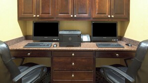 A workspace with two desktop computers, a printer, and two chairs. - Holiday Inn Express Tower Center by IHG (East Brunswick)