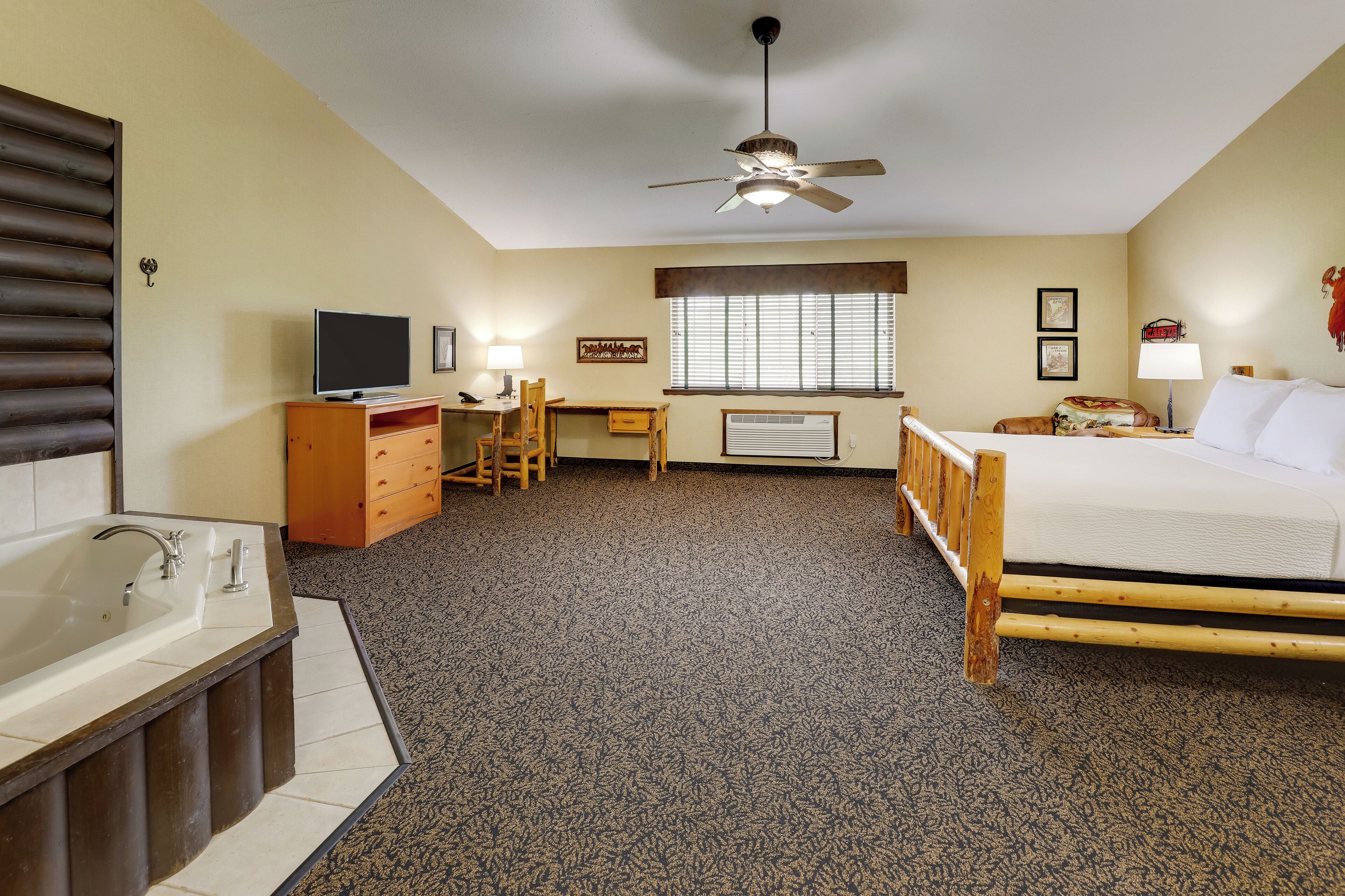 suite, 1 king bed, hot tub | desk, laptop workspace, iron/ironing board, free cots/infant beds