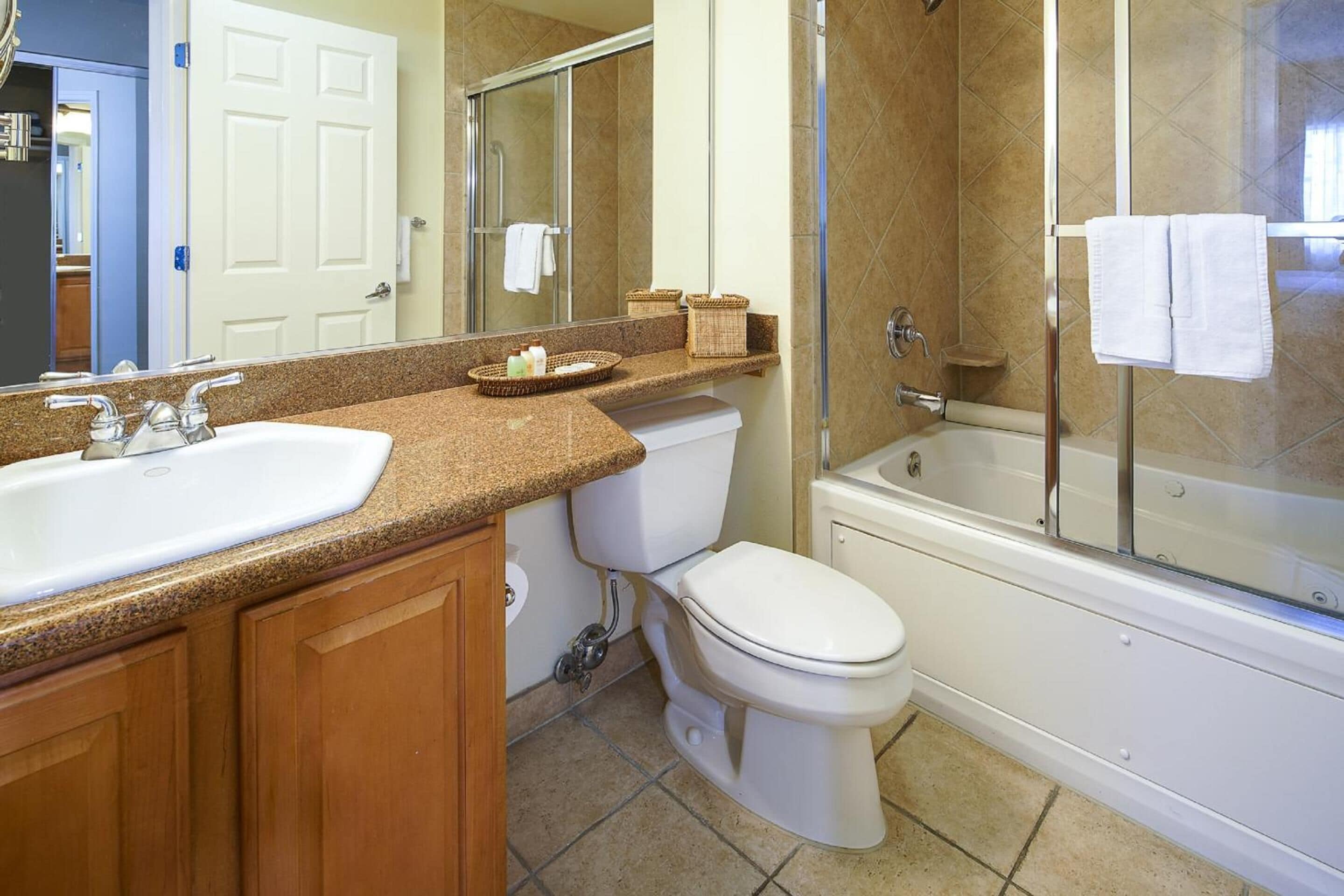A bathroom with a sink, toilet, and bathtub.