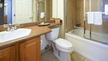 A bathroom with a sink, toilet, and bathtub.