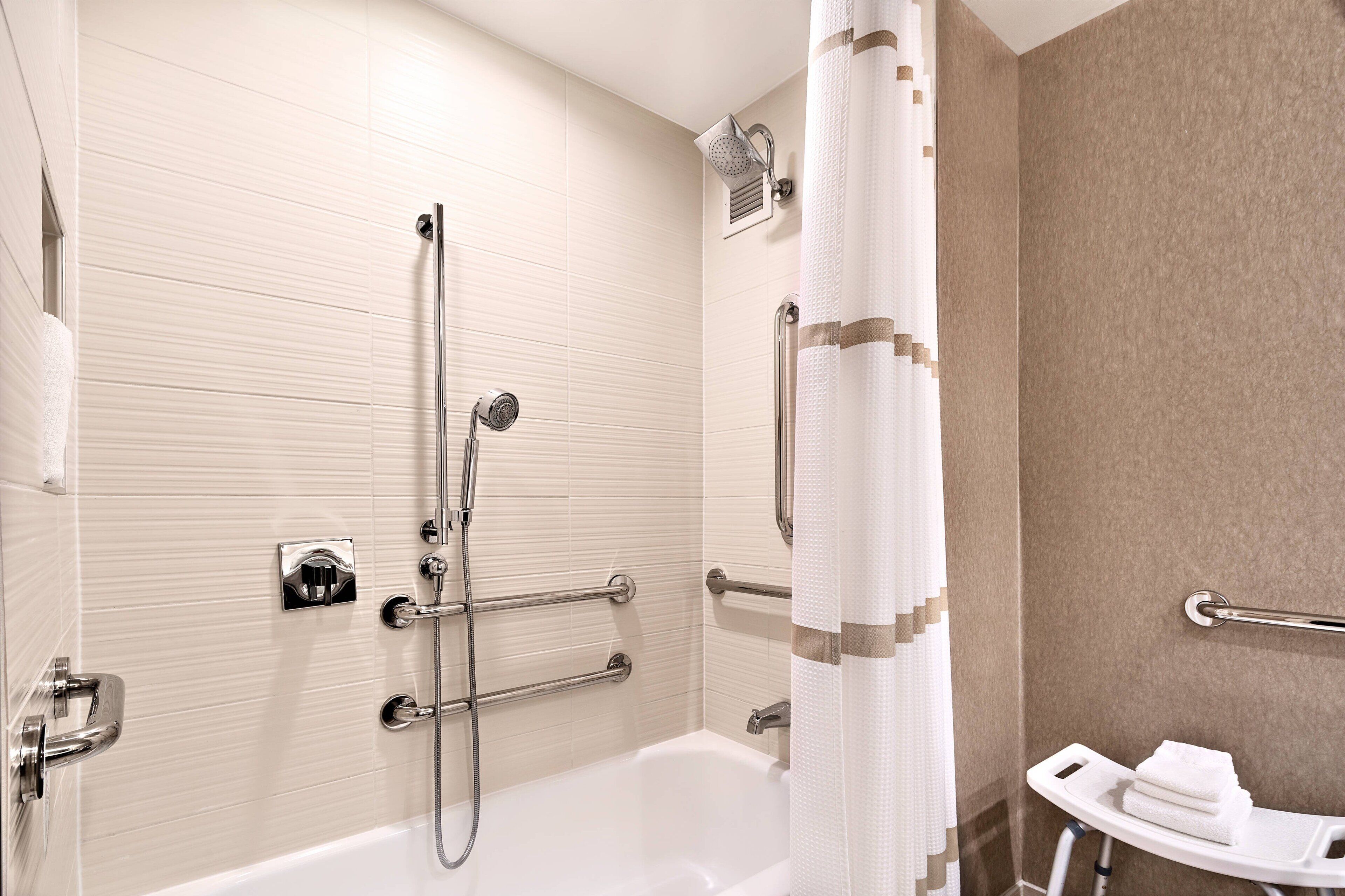 combined shower/bathtub, designer toiletries, hair dryer, bathrobes