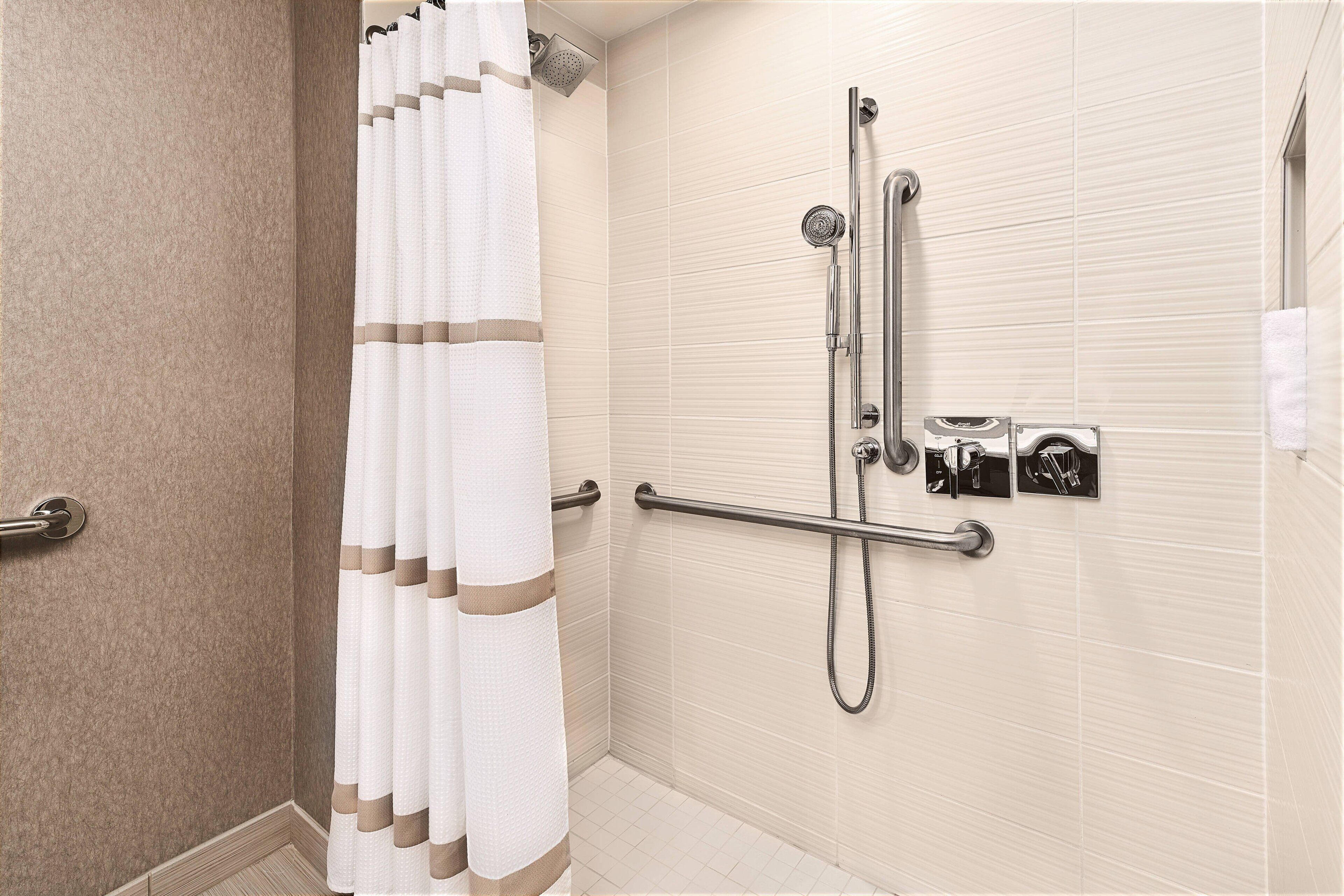combined shower/bathtub, designer toiletries, hair dryer, bathrobes