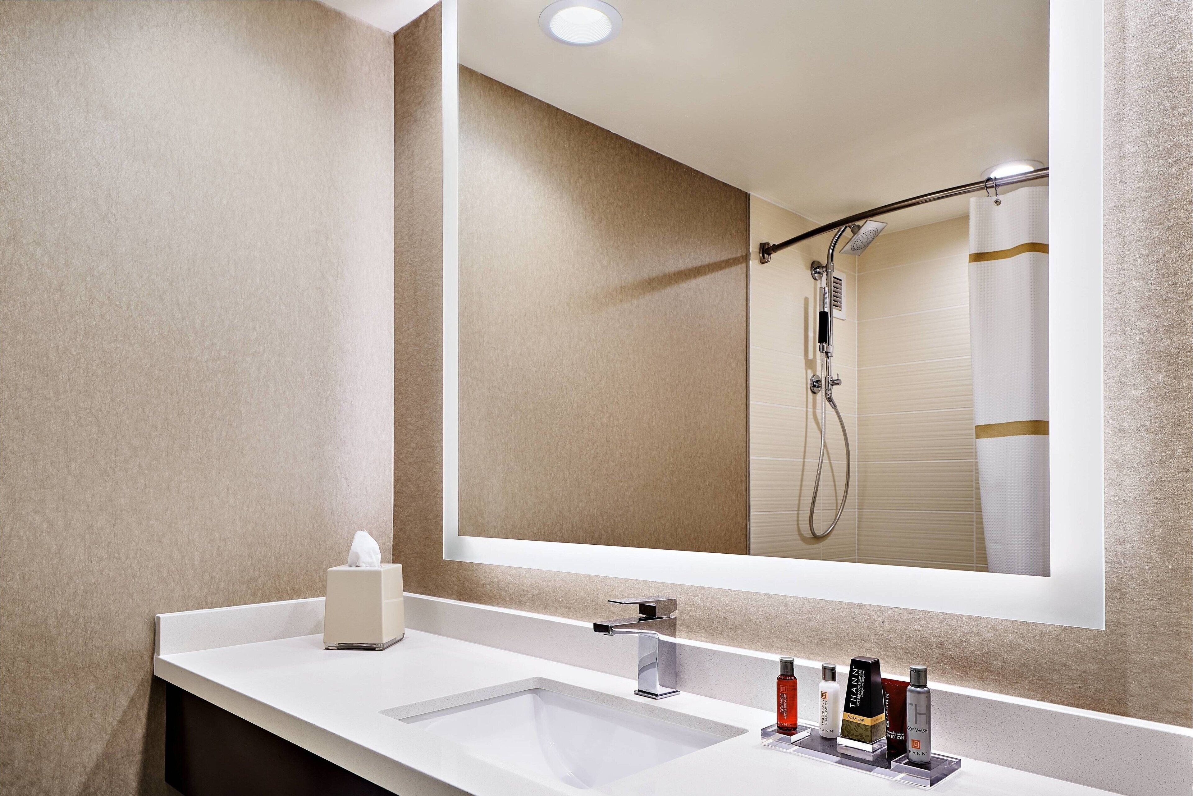 combined shower/bathtub, designer toiletries, hair dryer, bathrobes