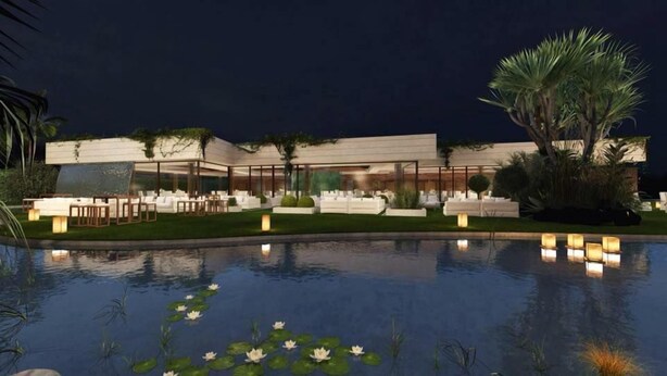 A modern hotel with a pool, outdoor seating, and a well-maintained garden.